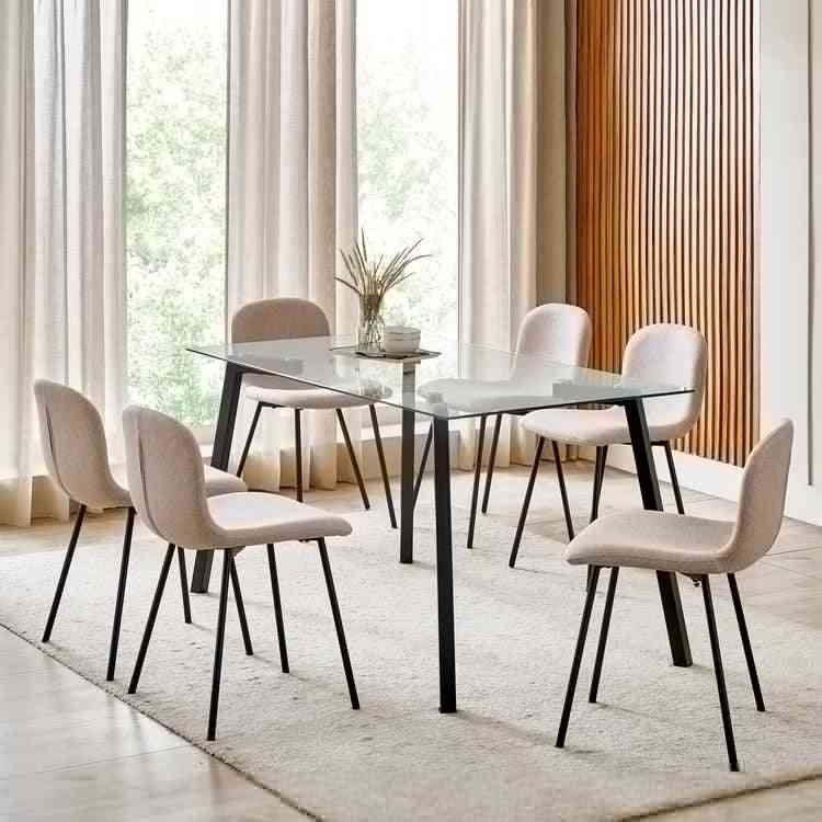 Solid timber dining tables and sculpted wooden chairs