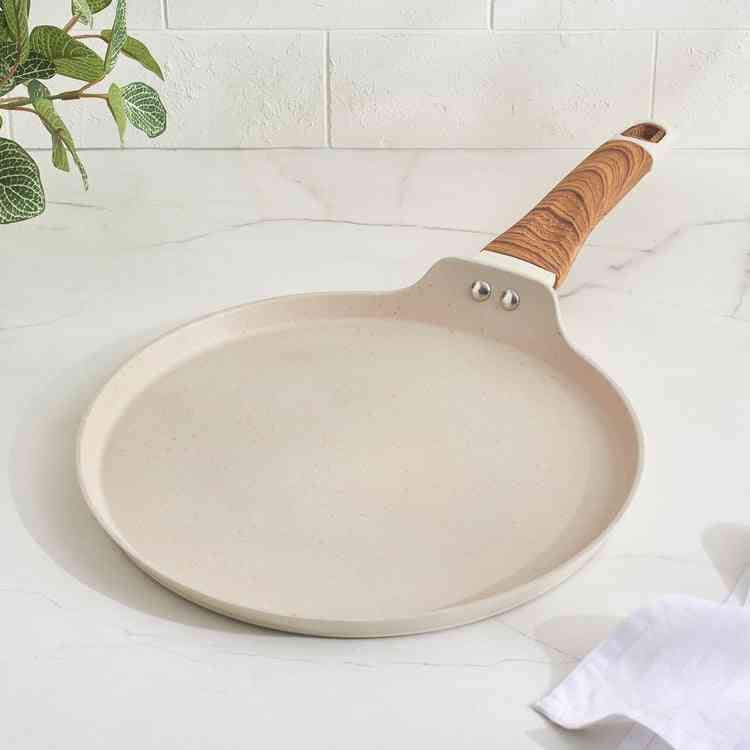 Artisan enamel pans, ceramic bowls, and culinary tools